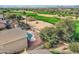 Aerial view showcasing the home's pool, landscaping, and access to the lush green golf course at 30626 N 45Th Pl, Cave Creek, AZ 85331