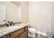 Powder room with granite countertop vanity and toilet at 30626 N 45Th Pl, Cave Creek, AZ 85331