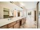 Bathroom featuring dual sinks, a large mirror, and a separate shower and toilet area at 30626 N 45Th Pl, Cave Creek, AZ 85331