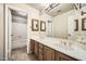 Well lit bathroom featuring a double sink vanity and a bathtub with shower at 30626 N 45Th Pl, Cave Creek, AZ 85331