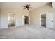 Spacious bedroom with multiple entryways, neutral carpet, and a ceiling fan at 30626 N 45Th Pl, Cave Creek, AZ 85331