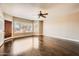 Bright bedroom with hard wood floors, a ceiling fan, and lots of natural light from large window with blinds at 30626 N 45Th Pl, Cave Creek, AZ 85331