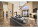 Staged living room with fireplace, high ceilings, neutral walls, tile floors, and access to outdoor patio at 30626 N 45Th Pl, Cave Creek, AZ 85331