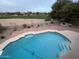 Backyard featuring blue pool, brick patio, grill, and views of golf course in distance at 30626 N 45Th Pl, Cave Creek, AZ 85331