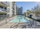 Community pool with lounge chairs and building view at 3131 N Central Ave # 6015, Phoenix, AZ 85012