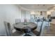 Modern round dining table with four chairs, near a kitchen with white cabinets at 3131 N Central Ave # 6015, Phoenix, AZ 85012