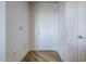 Modern apartment entryway with white door and wood-look floors at 3131 N Central Ave # 6015, Phoenix, AZ 85012