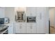 White kitchen cabinets with built-in wine cooler and microwave at 3131 N Central Ave # 6015, Phoenix, AZ 85012