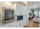 Stainless steel wine cooler and microwave in white kitchen at 3131 N Central Ave # 6015, Phoenix, AZ 85012