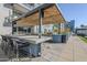 Outdoor kitchen with grill and bar seating under a pergola at 3131 N Central Ave # 6015, Phoenix, AZ 85012