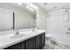 Bathroom with double vanity, tub, and tiled floor at 3167 E Battala Ct, Gilbert, AZ 85297