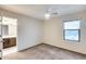 Bedroom with carpet, ceiling fan, and access to a bathroom at 3167 E Battala Ct, Gilbert, AZ 85297