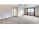 Carpeted bedroom with ceiling fan and access to a hallway at 3167 E Battala Ct, Gilbert, AZ 85297