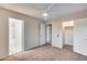 Bedroom with carpet, ceiling fan, and adjacent bathroom and closet at 3167 E Battala Ct, Gilbert, AZ 85297