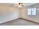 Bedroom with carpeted floor, ceiling fan, and window with view at 3167 E Battala Ct, Gilbert, AZ 85297