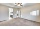 Bedroom with carpet, ceiling fan, and ensuite bathroom access at 3167 E Battala Ct, Gilbert, AZ 85297