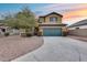 Two-story house with a green garage door and landscaping at 3167 E Battala Ct, Gilbert, AZ 85297