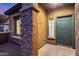 Front entrance with a green door and stone accents at 3167 E Battala Ct, Gilbert, AZ 85297