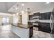 Modern kitchen with dark cabinetry and granite island at 3167 E Battala Ct, Gilbert, AZ 85297