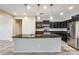 Modern kitchen with dark cabinetry and granite island at 3167 E Battala Ct, Gilbert, AZ 85297