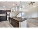 Modern kitchen with dark cabinetry and granite island at 3167 E Battala Ct, Gilbert, AZ 85297