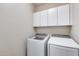 Laundry room with washer, dryer, and upper cabinets at 3167 E Battala Ct, Gilbert, AZ 85297