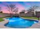 A private pool with a rock waterfall feature enhances this backyard oasis, perfect for relaxing and entertaining at 3167 E Battala Ct, Gilbert, AZ 85297