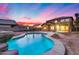 Inviting kidney-shaped pool in the backyard at sunset at 3167 E Battala Ct, Gilbert, AZ 85297