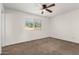 Spacious bedroom with ceiling fan and neutral carpeting at 3214 W Grovers Ave, Phoenix, AZ 85053