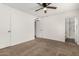 Bright bedroom with ceiling fan, carpet, and access to bathroom at 3214 W Grovers Ave, Phoenix, AZ 85053