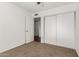 Spacious bedroom with sliding door closet and carpet flooring at 3214 W Grovers Ave, Phoenix, AZ 85053