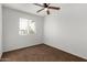 Well-lit bedroom featuring a ceiling fan and brown carpet at 3214 W Grovers Ave, Phoenix, AZ 85053