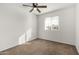 Bright bedroom with window, ceiling fan and brown carpet at 3214 W Grovers Ave, Phoenix, AZ 85053