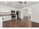 Modern kitchen with white cabinets, stainless steel appliances, and wood-look tile floors at 3214 W Grovers Ave, Phoenix, AZ 85053