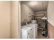 Laundry room with washer, dryer, and extra shelving at 3214 W Grovers Ave, Phoenix, AZ 85053