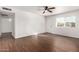 Bright living room with wood-look tile floors and ceiling fan at 3214 W Grovers Ave, Phoenix, AZ 85053