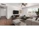 Bright living room with a ceiling fan, modern decor, and a large window for natural light at 3214 W Grovers Ave, Phoenix, AZ 85053