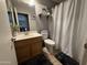 Bathroom featuring a vanity, toilet, and shower with decorative shelf and modern accents at 3560 W Tina Ln, Glendale, AZ 85310