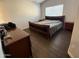 Bedroom featuring wood flooring, neutral walls, window, and modern furniture at 3560 W Tina Ln, Glendale, AZ 85310