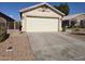 Spacious two-car garage with a concrete driveway and low-maintenance desert landscaping at 3560 W Tina Ln, Glendale, AZ 85310