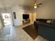 Inviting living room featuring an open layout, tile flooring, and a view of the front entrance at 3560 W Tina Ln, Glendale, AZ 85310