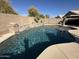 Backyard pool with a tanning ledge and a small waterfall feature at 3560 W Tina Ln, Glendale, AZ 85310