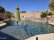 Inviting backyard pool with waterfall features, lush greenery, and ample space for relaxation at 3560 W Tina Ln, Glendale, AZ 85310