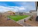 Landscaped backyard with putting green, playset, and trampoline at 36060 W Santa Clara Ave, Maricopa, AZ 85138