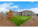 Spacious backyard with putting green, playset, and trampoline at 36060 W Santa Clara Ave, Maricopa, AZ 85138