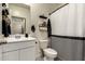 Clean bathroom with white vanity and black and white shower curtain at 36060 W Santa Clara Ave, Maricopa, AZ 85138