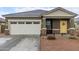 Newly built home with a two-car garage and yellow door at 36060 W Santa Clara Ave, Maricopa, AZ 85138