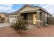 Modern home with a two-car garage and yellow front door at 36060 W Santa Clara Ave, Maricopa, AZ 85138