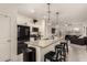 Modern kitchen island with granite countertops and black appliances at 36060 W Santa Clara Ave, Maricopa, AZ 85138