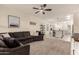 Open living area with a sectional sofa and kitchen view at 36060 W Santa Clara Ave, Maricopa, AZ 85138